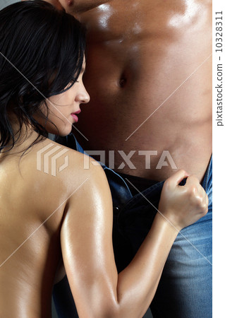 Beautiful brunette undressing her lover, close-up 10328311