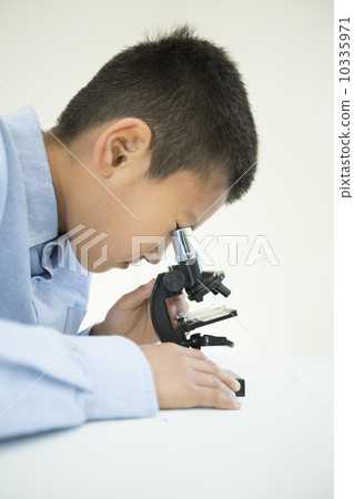 A boy using a microscope A boy using a microscope 10335971