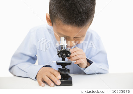 A boy using a microscope A boy using a microscope 10335976
