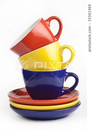 pile of colorful cups on a white background 10381468