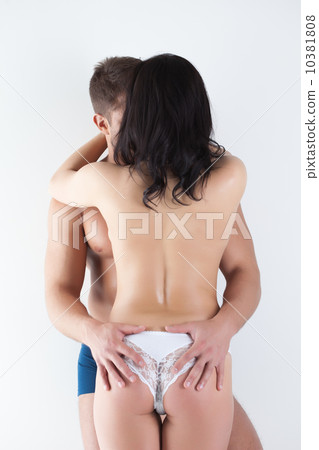 Rear view of young people embracing in studio 10381808