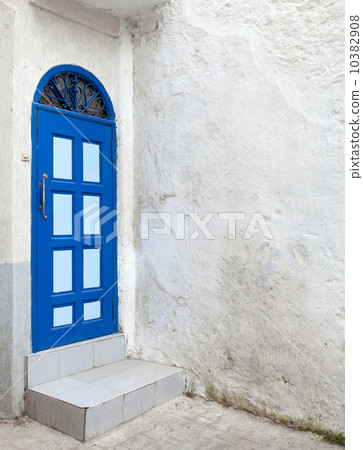 Blue door and white walls. Old Medina, historical part of Tanger 10382908
