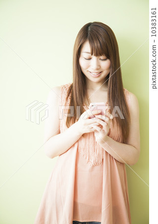 Woman holding a smartphone Woman holding a smartphone 10383161