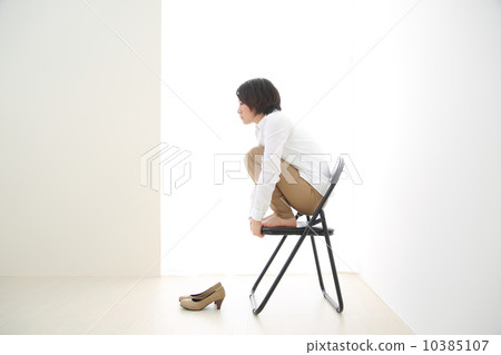 A woman sitting on a pipe chair A woman sitting on a pipe chair 10385107