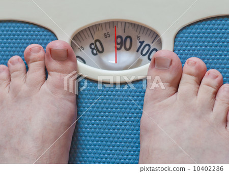 Close-up of man feet weighing in bathroom 10402286