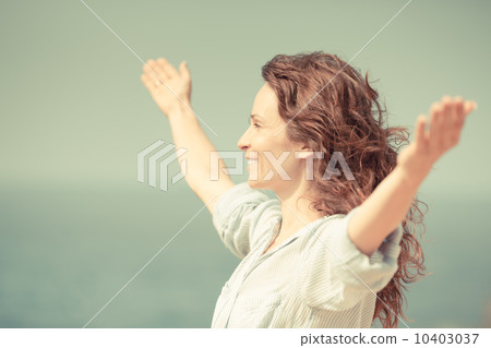Happy woman relaxing at the beach 10403037