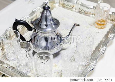 Moroccan tea theme. Metal teapot with glasses 10403684