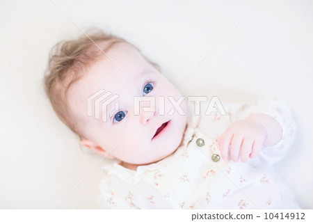Adorable baby girl wearing an elegant lace shirt 10414912