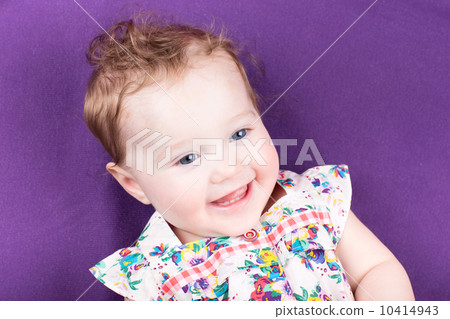 Laughing baby girl on a purple blanket Laughing baby girl on a purple blanket 10414943
