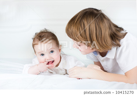 Cute brother and baby sister playing together 10415270