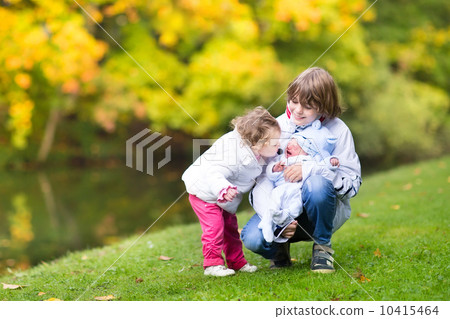 Brother and his little toddler sister comforting and kissing the 10415464
