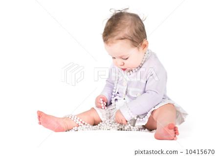 Cute baby girl playing with pearls 10415670