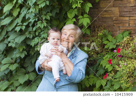 Great-grandmother holding a newborn baby 10415909