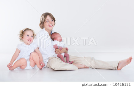Portrait of three siblings, school age boy, his toddler sister a Portrait of three siblings, school age boy, his toddler sister a 10416151