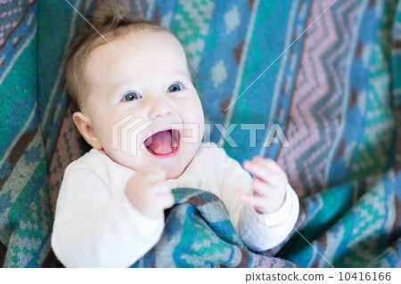 Laughing happy baby under a warm blanket Laughing happy baby under a warm blanket 10416166
