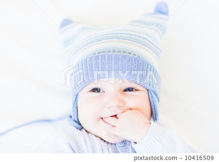 Little baby in a funny blue hat on white background Little baby in a funny blue hat on white background 10416509