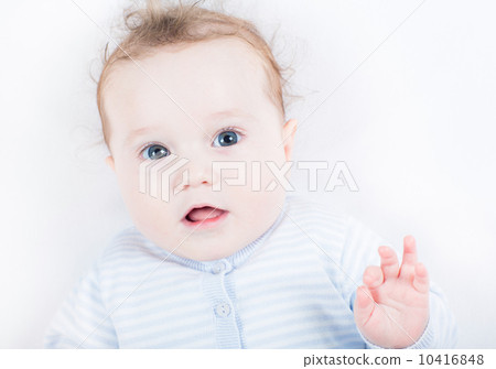 Little baby in a blue knitted sweater watching attentively Little baby in a blue knitted sweater watching attentively 10416848