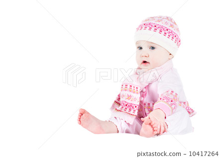 Beautiful baby girl in a knitted sweater, hat and scarf, isolate 10417264