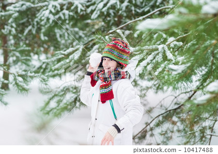 Funny cute boy playing snow ball in a snowy winter park in his C Funny cute boy playing snow ball in a snowy winter park in his C 10417488