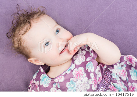 Beautiful little girl in a purple dress Beautiful little girl in a purple dress 10417519