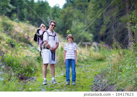 Happy young family, active father, his son and a baby daughter h 10417623