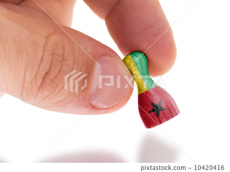 Hand holding wooden pawn, flag painting, selective focus Hand holding wooden pawn, flag painting, selective focus 10420416