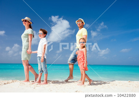 Family on a tropical beach vacation 10422880