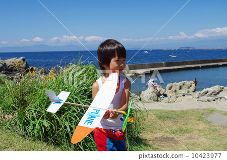 飛行在海岸的孩子一架式樣飛機 10423977