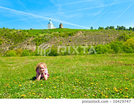 Small girl on spring blossoming field 10429747