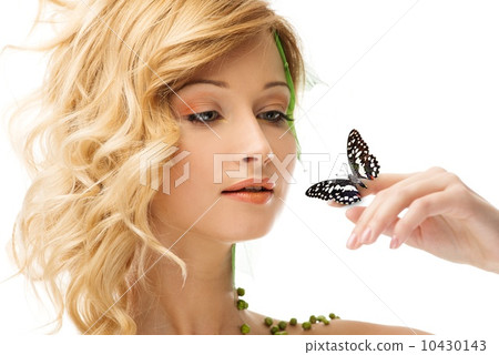 Dreaming young woman in conceptual spring costume with butterfly on her hand 10430143