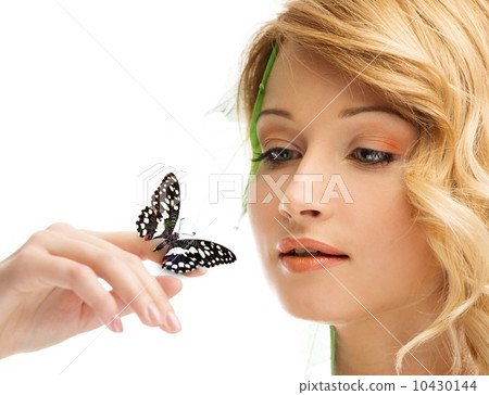 Dreaming young woman in conceptual spring costume with butterfly on her hand 10430144