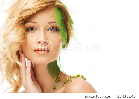 Beautiful young woman in conceptual spring costume touching her face 10430145