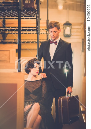 Beautiful vintage style couple inside retro train coach Beautiful vintage style couple inside retro train coach 10430901