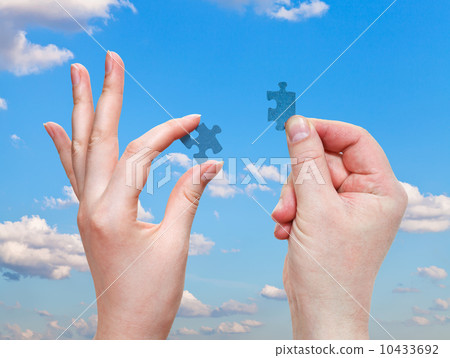 male and female hands with little puzzle pieces 10433692