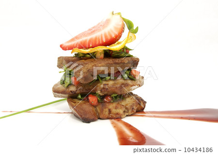 Roast goose liver is decorated with greens and strawberries Roast goose liver is decorated with greens and strawberries 10434186