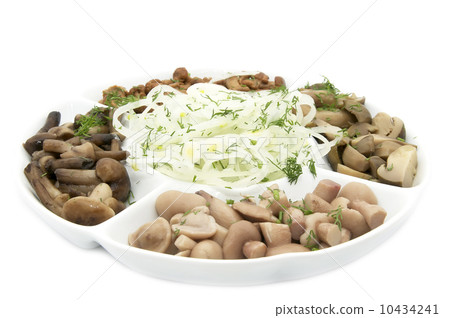 assorted mushrooms with onions on a white background in the restaurant 10434241
