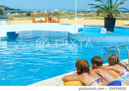 Mother with her children near swimming pool. 10434608
