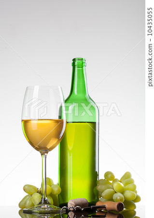 White wine in glass with grape and bottle White wine in glass with grape and bottle 10435055