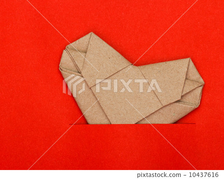 Origami recycle paper heart on red paper 10437616