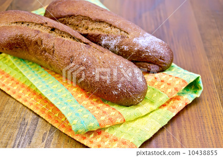 Rye baguettes on a napkin and board Rye baguettes on a napkin and board 10438855
