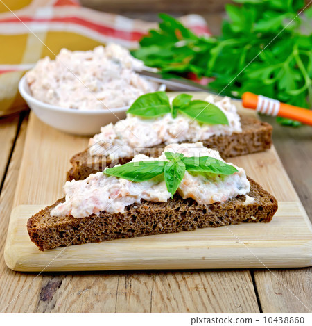 Sandwich with cream of salmon and knife on board Sandwich with cream of salmon and knife on board 10438860