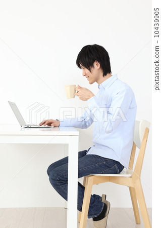 A man watching a laptop A man watching a laptop 10439905