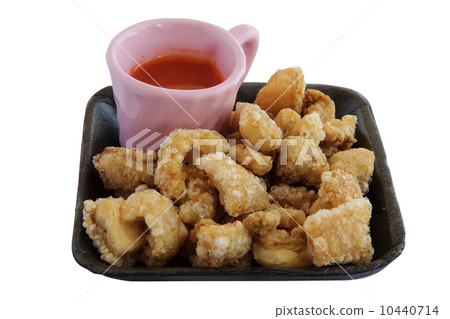 fried pork rinds with sauce an isolate 10440714