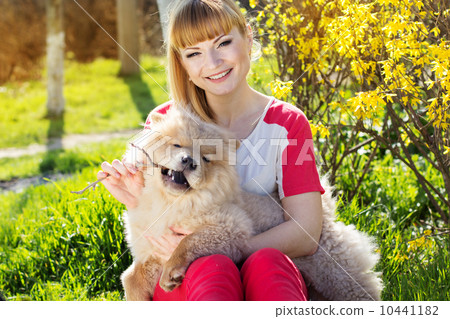 Portrait of a woman with her dog outdoors Portrait of a woman with her dog outdoors 10441182