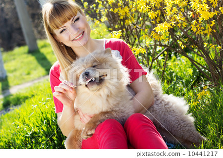 Portrait of a woman with her dog outdoors Portrait of a woman with her dog outdoors 10441217