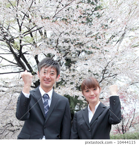Men and women of suits in front of cherry blossoms Men and women of suits in front of cherry blossoms 10444115