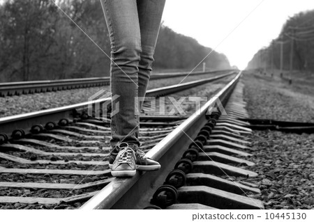 Girl walking across railroad. B&W image 10445130