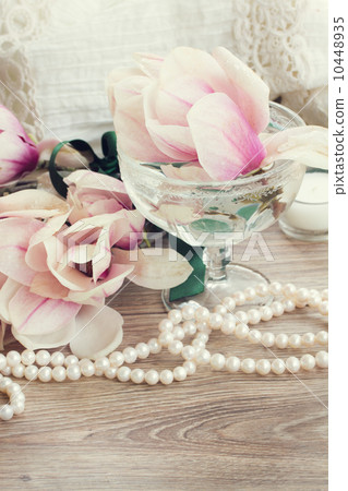 magnolia flowers with pearls on wooden table magnolia flowers with pearls on wooden table 10448935