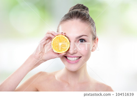 Beautiful woman face with juicy orange 10451639