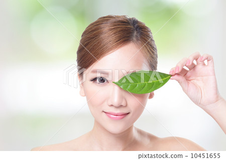 beautiful woman face portrait with green leaf 10451655